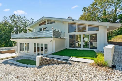 a white house with a lawn in front of it at Upscale Modern Home with perfect triad location in High Point