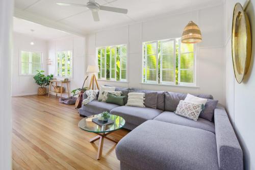 a living room with a couch and a table at Moffat Beach Entertainer with Kids Retreat & Walk to Beach in Caloundra
