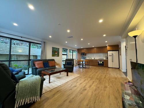 a living room with a couch and a table at NO PARTY ALLOWED, Entire Brand New 3 bedroom townhouse, free unlimited fibre wifi and free parking in Wellington