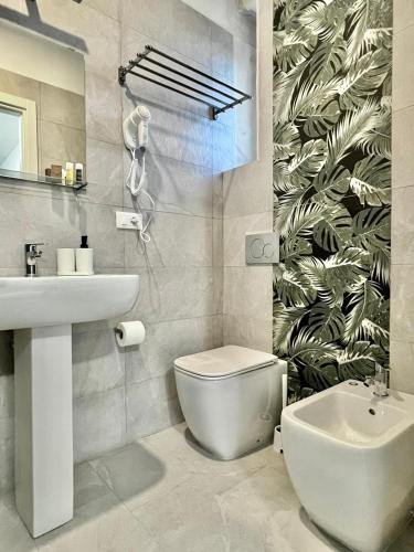 a bathroom with a white toilet and a sink at Dimore Hyblon in Cassaro