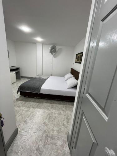 a bedroom with a bed in a room with a door at Hotel Armenia Lions in Armenia