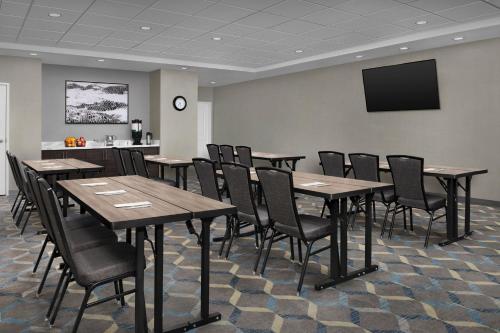 a conference room with tables and chairs and a tv at Residence Inn by Marriott Galveston Island in Galveston