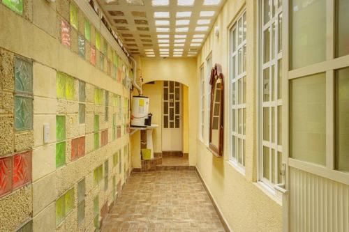 a hallway of a building with colorful tiles on the walls at Departamento céntrico 10 minutos aeropuerto CDMX in Ciudad Nezahualcóyotl