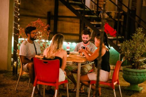 a group of people sitting around a table at Hangover Hostels Mirissa in Mirissa