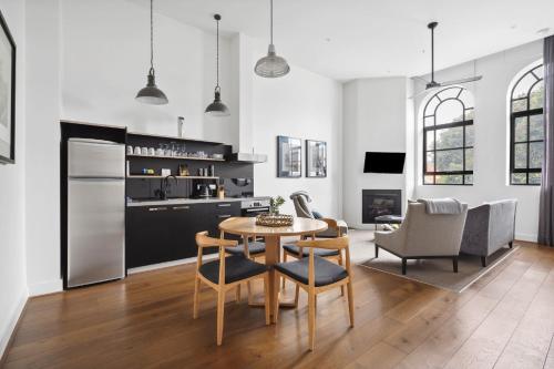 a kitchen and dining room with a table and chairs at Devlin 103 Luxe Apartment in Geelong