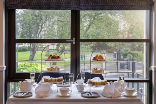 a table with cakes and desserts on a window at Delta Hotels by Marriott Liverpool City Centre in Liverpool