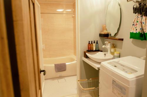 a bathroom with a sink and a bath tub at 7 Rooms Hotel & Cafe - 30mins from Disneyland in Tokyo