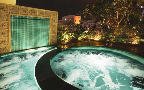 a jacuzzi bathtub in a room with at Alagon D'antique Hotel & Spa - Wellness Treatment Included in Ho Chi Minh City