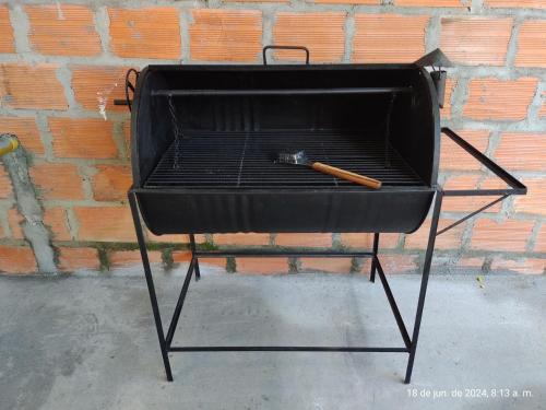 a black grill with a baseball bat on it at Casa Valentina habitación#2 para 6 personas in Guamo