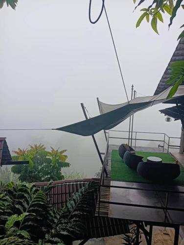 a hammock sitting on top of a house at SANKARA GARDEN in Pantai