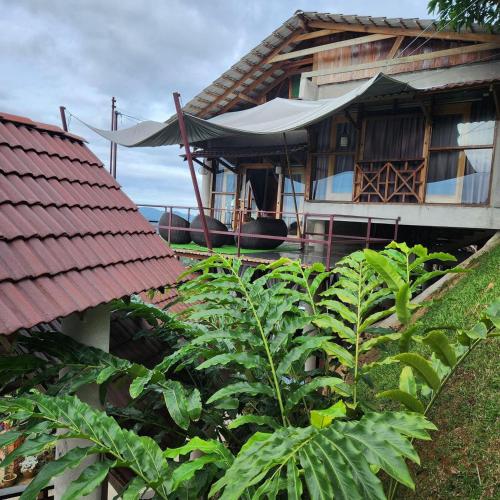 a house with a tarp on the side of it at SANKARA GARDEN in Pantai