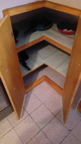 a wooden cabinet with a shelf with a bowl at Casa Guadalupe Victoria in Matamoros