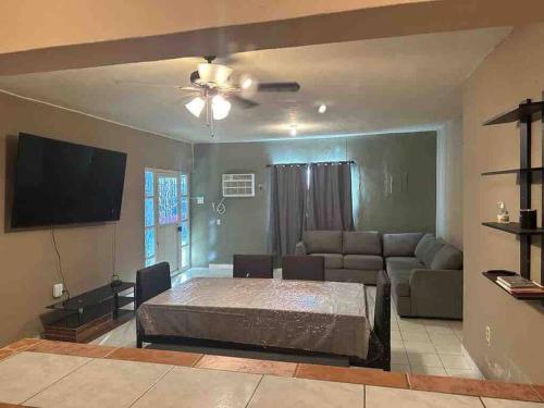 a living room with a bed and a couch at Casa Guadalupe Victoria in Matamoros
