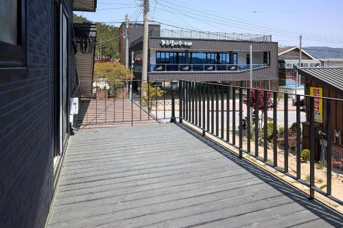 a boardwalk leading to a building with a train at Ronnie Pension in Taean