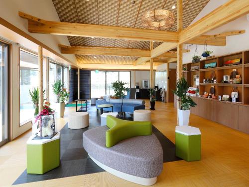 a lobby with green and white chairs and tables at Bettei Wankobiyori in Ashikita