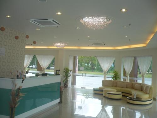 a living room with a couch and a chandelier at Zara's Boutique Hotel @ Harbour City in Kota Kinabalu