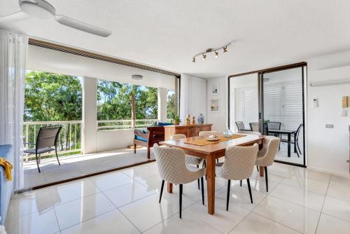 a dining room with a table and chairs at Argosy On The Beach in Clifton Beach