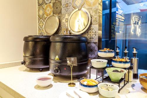 a display of bowls and plates on a table at Nost algia S Hotel Near Chengdu Kuanzhai Alley - People's Park, Chengdu Panda Base, 10 minutes walk to subway , Free laundry, English communication well, Free coffee,Free travel advice in Chengdu