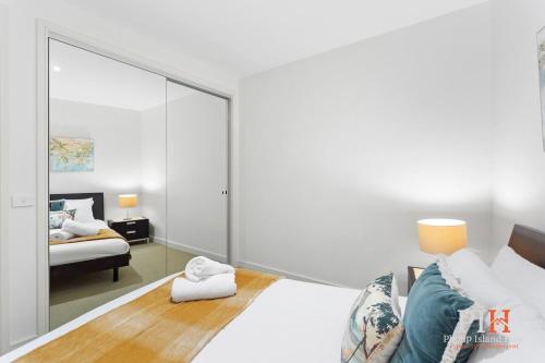 a bedroom with a bed and a mirror at Penthouse Waterfront Apt Sleep 4 in Cowes