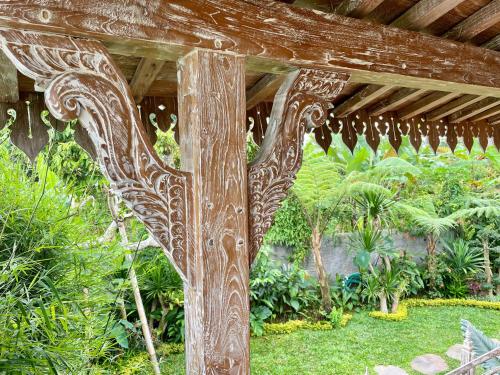 a wooden structure in the middle of a garden at JANE’S HOUSE & SPA BEDUGUL BALI in Patjung