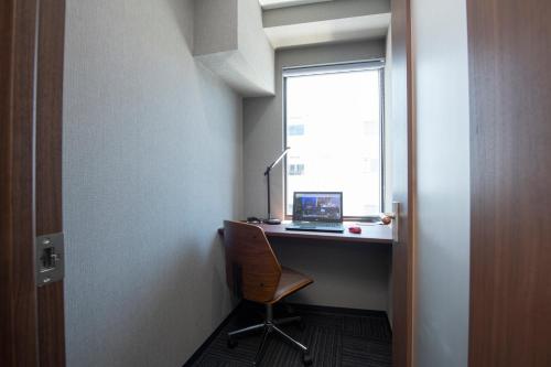 a room with a desk with a laptop and a window at ENT TERRACE Asakusa in Tokyo