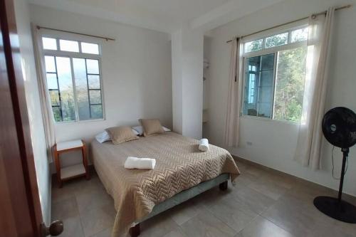 a bedroom with a bed with two towels on it at Suite Brisa del Mar - Cabañas Don Jorge in San Cristobal