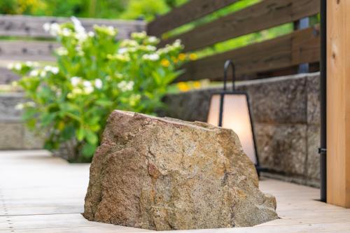 a rock sitting next to a lamp on a patio at Juju Kiseki House in Naoshima
