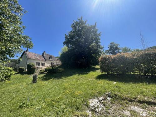 an old house in a grassy field with trees at Domaine du Bonheur en Pierre avec Piscine, Proche Sarlat in Carlux