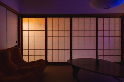 a room with a table and a window at Juju Kiseki House in Naoshima