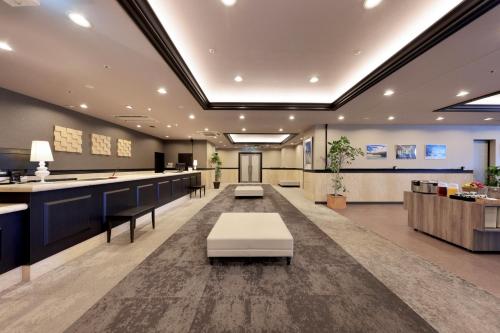 an office lobby with a reception desk and a waiting room at Minamisenri Crystal Hotel in Suita