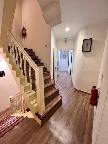 a hallway with a staircase in a house at H Hotel in Taipei