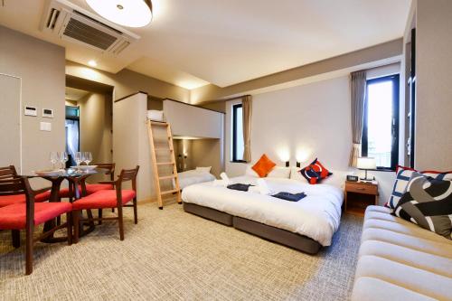 a hotel room with a bed and a dining room at ENT TERRACE AKIHABARA in Tokyo