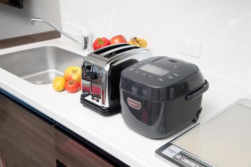 a toaster sitting on a kitchen counter next to a sink at ENT TERRACE AKIHABARA in Tokyo