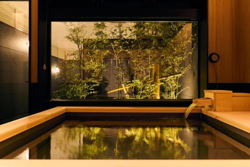 a room with a window with a pool of water at Amakusa Santacoming Hotel in Amakusa