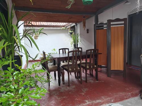 a dining room table and chairs on a patio at Irene's Home in Matale
