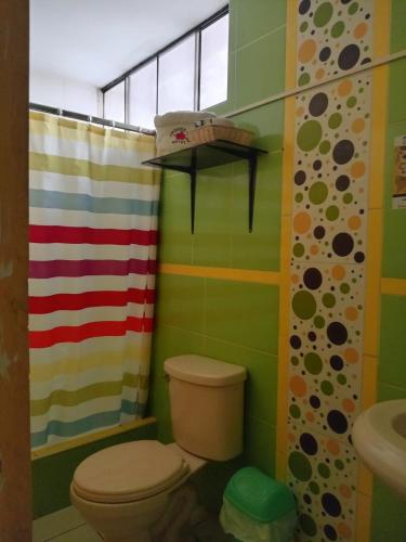 a bathroom with a toilet and a shower at Orquídea's Hotel in Piura