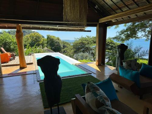 a living room with a view of a pool at Manga Soa Lodge in Fascène - Befefika