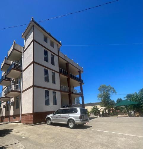 a car parked in front of a building at Batumi Aparthotel 22D in Batumi
