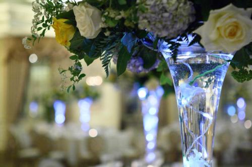 a blue vase with flowers in it on a table at Kabira Country Club in Kampala