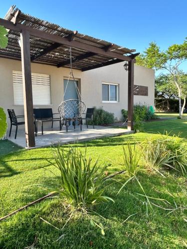 a patio with a swing in a yard at צימר מול השקיעה in Retamim