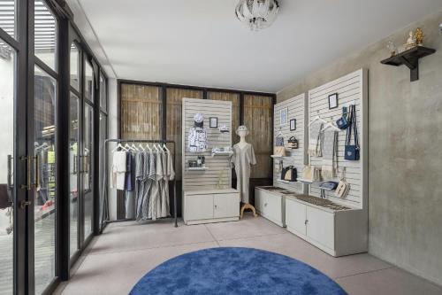 a clothing store with a blue rug and windows at Homm Chura Samui in Chaweng