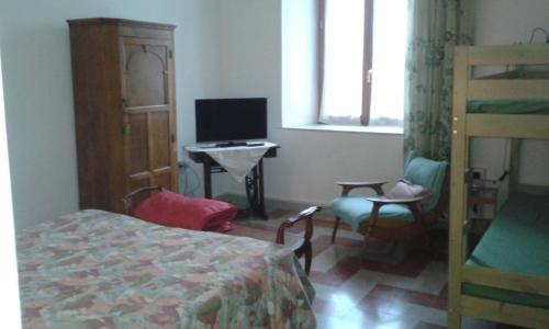 a bedroom with a bed and a desk and a television at Da Anita in Rome