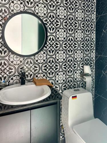 a bathroom with a sink and a mirror at Nereus Hotel in Con Dao