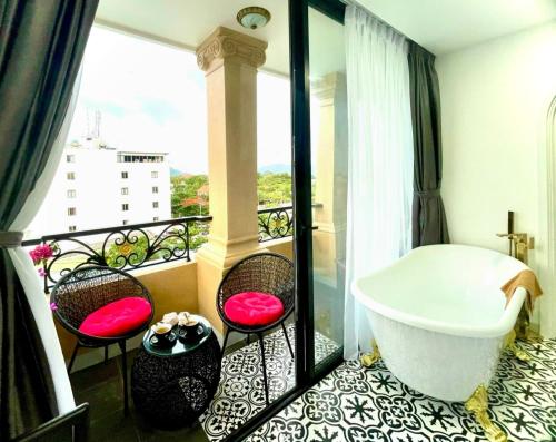 a bathroom with a bath tub on a balcony at Nereus Hotel in Con Dao