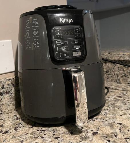 a black toaster sitting on top of a counter at Mae Sweet Home in Surrey
