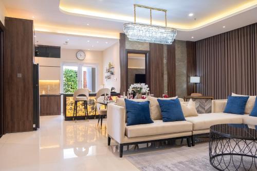 a living room with a couch and a dining room at BEST WORLD KINDAI HOTEL in Banjarmasin