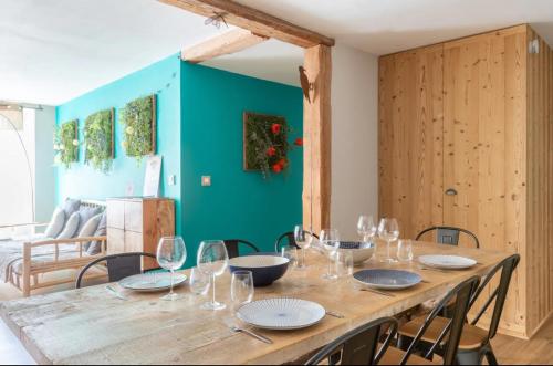 - une table en bois avec des chaises et des verres à vin dans l'établissement Le Nature à Kaysersberg + 1 place de parking, à Kaysersberg