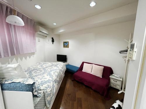 a small bedroom with a bed and a chair at Ocean Villa Tin Gala in Onna
