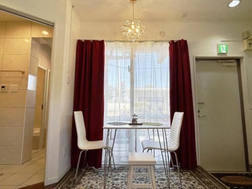 a dining room with a table and chairs and a window at Ocean Villa Tin Gala in Onna