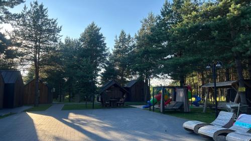 a park with a playground and a play area at Ośrodek u Polaka-domek góralski in Radkowice